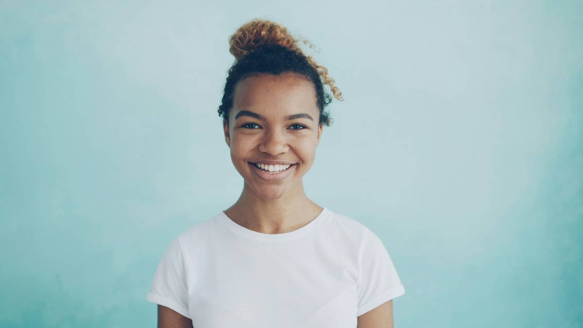 Elegant hair bun designs on textured curly hair using the pineapple-to-bun transition